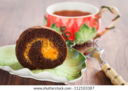 Chocolate swiss roll with pumpkin and orange. Selective focus