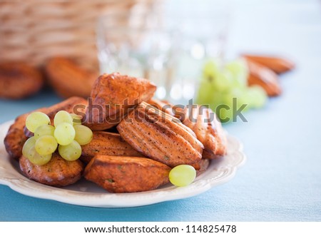 Cheese oat bran madeleines cookies with paprika and grapes. Selective focus