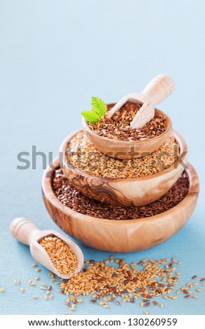 Flax seeds white and brown in wooden bowl. Selective focus
