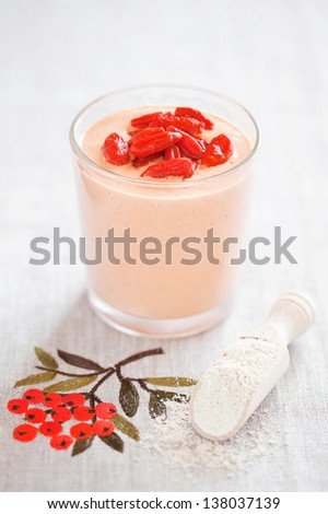 Smoothie with goji berries and oat bran powder, selective focus