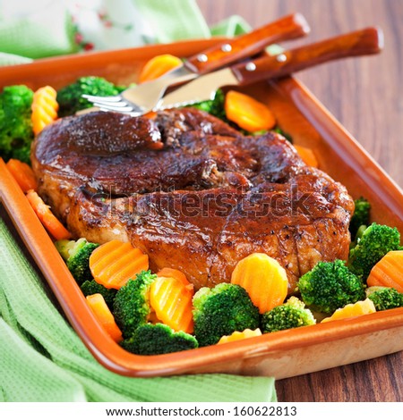Honey glazed roast pork, carrots and broccoli. Selective focus
