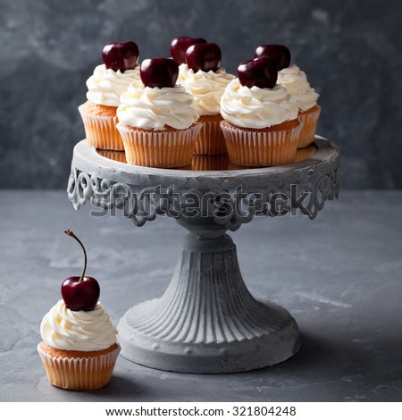 Cherry cupcakes on a cake stand, selective focus