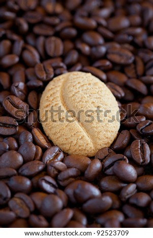 Coffee bean cookie on coffee beans, selective focus