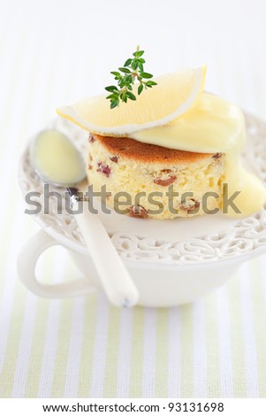 Lemon and raisin cake slice with lemon sauce, selective focus