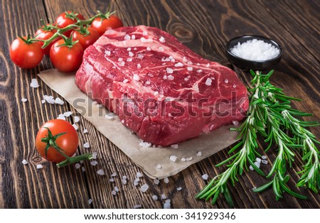 Raw marbled meat steak Ribeye on dark wooden background