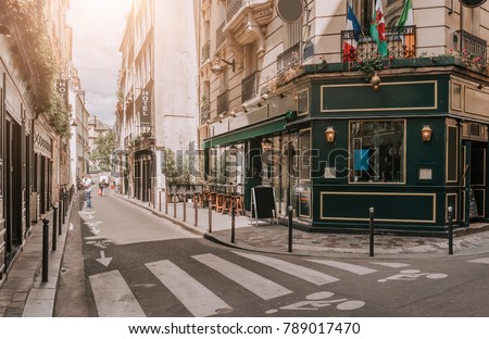 Cozy street with tables of irish pub in Paris, France. Architecture and landmarks of Paris. Postcard of Paris