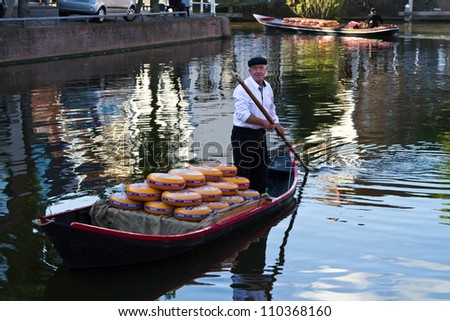 ALKMAAR, NETHERLANDS - AUGUST 10: Cheese arrives to the cheese market by boat on August 10, 2012 in Alkmaar, Netherlands. Every friday morning there is a typical cheese market at Alkmaar.