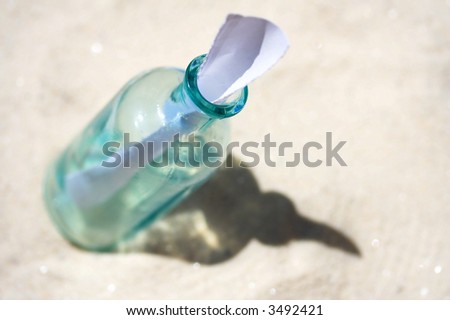 Blank paper in Bottle in sand