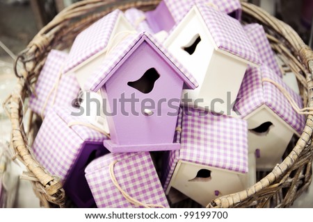 Straw basket full of handmade bird houses