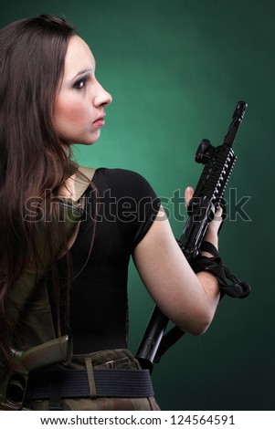 Beautiful woman with rifle plastic Military Army girl Holding Gun green background