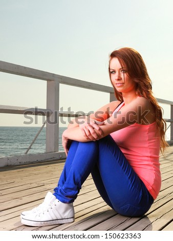 Attractive girl Young woman on pier Sits Relaxing Old Wooden Pier