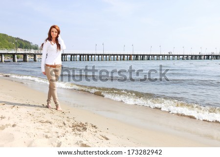 The young happy woman on a beach sea and sky vacation