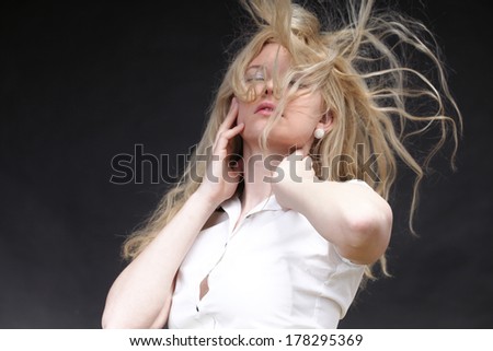 Blonde woman with her hair blowing in the wind
