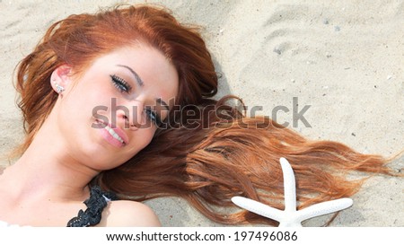 The beautiful girl lies on sea coast with shells nature vacation woman
