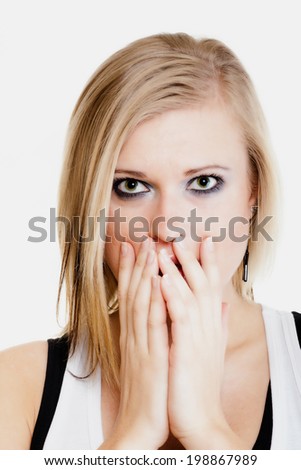 Body language and emotions. Surprised afraid blonde girl shocked young woman covering mouth with hand isolated on white.
