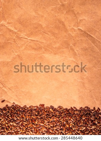 Healthy diet organic nutrition. Brown raw flax seeds linseed border frame on paper background