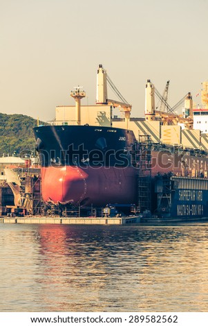 GDYNIA, POLAND - JUNY 13: Drydock in Shipyard, large ship under repair in dry dock on Juny 13, 2015, Poland.