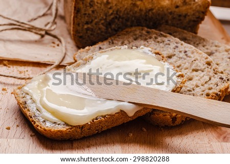 Still life fresh  whole wheat bread with butter and honey rustic wooden table background