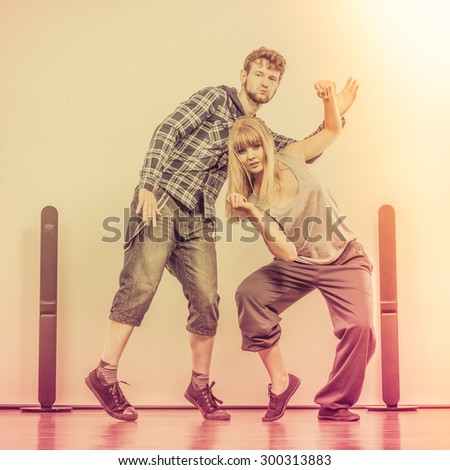 Two modern dancers couple woman and man dancing in the garage. Urban lifestyle. Hip-hop generation.