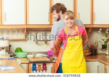 People, housework and housekeeping concept. Couple doing the washing up together in kitchen interior