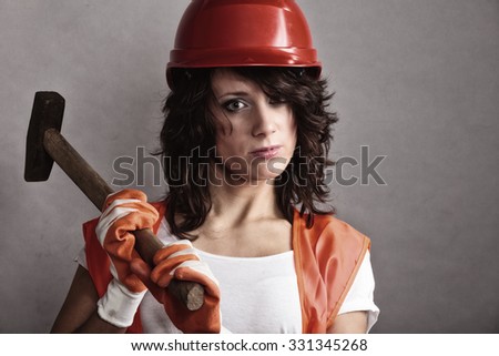 Sex equality and feminism. Sexy girl in safety helmet orange vest holding hammer tool. Attractive woman working as construction worker.