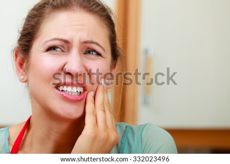 Mature woman female suffering from toothache tooth pain.