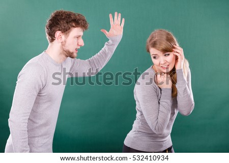 Violence against woman. Aggressive man yelling shouting on scared afraid woman. Negative relations in partnership. Expressive young male beating frightened lady.
