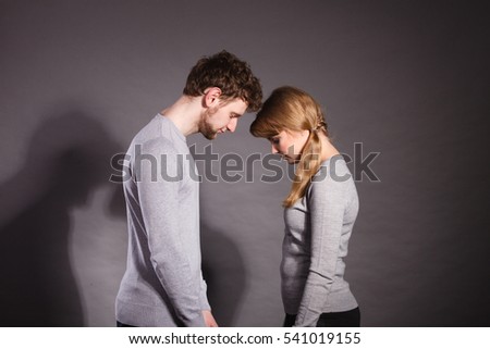 Depression and sadness concept. Unhappy depressed couple after argument. Sad woman and disappointed man standing together.