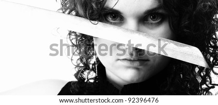 Girl - woman dark curly hair natural brown-haired holding in her hands a katana sword black and white