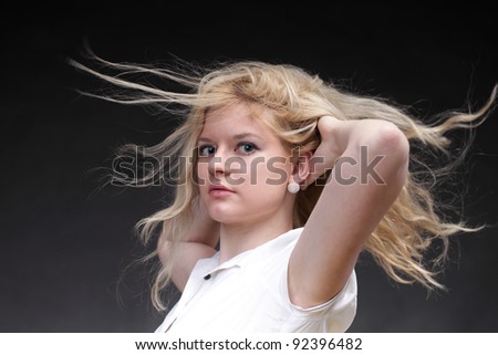 Blonde woman with her hair blowing in the wind