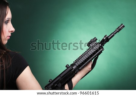 Beautiful woman with rifle plastic Military Army girl Holding Gun green background