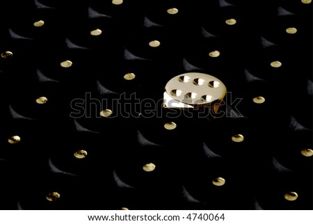 a golden dice showing six between a mess of black ones