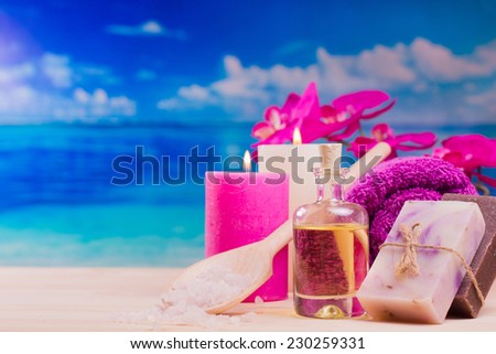 Image of spa concept with flowers, candles, sea salt, oil, towel and natural bar of soap