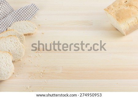 Sliced rustic bread on wooden table background. Your text here