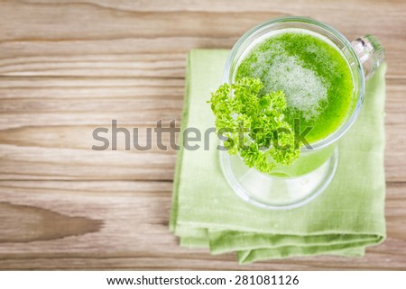Healthy vegetable smoothie green juice on wooden table
