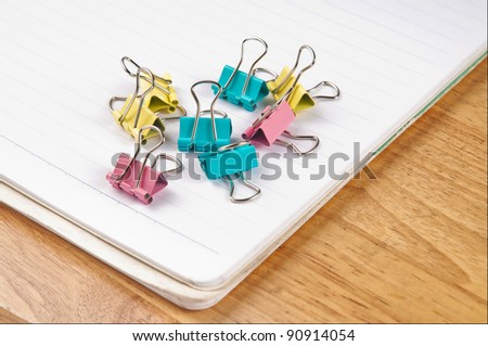 paper clip and notebook on the table