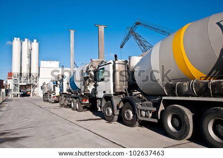Concrete mixing trucks on an industrial site