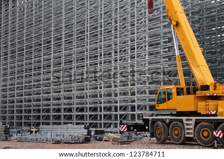 Steel structure of a high rack warehouse and a crane during construction
