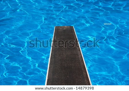 Swimming pool with diving board and reflections