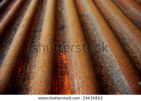 Lines of a rusty corrugated metal shield