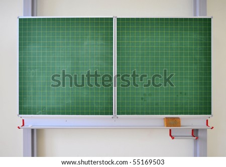 Green black board on the wall of a school