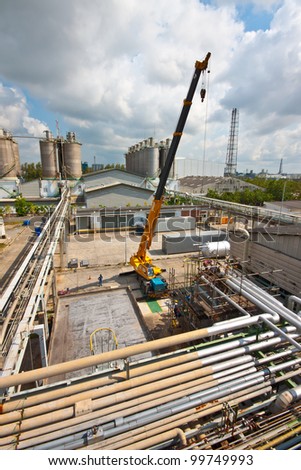 crane standing on a construction site under construction petrochemical plants
