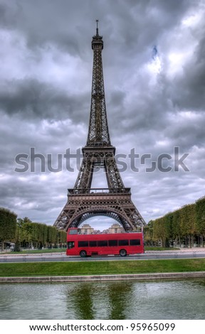 dark scene of Eiffel tower in Paris, France and red bus