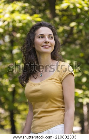 Portrait of a beautiful young woman at park  looking at the sky