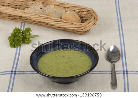 bowl with courgette soup and bread