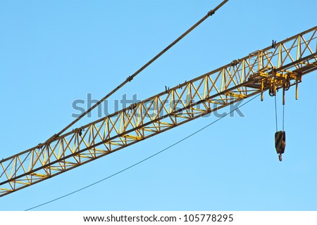 Part of a yellow construction tower crane