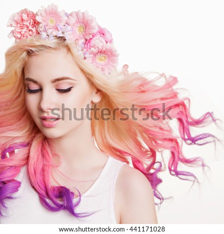 Youth women with curly colored hair and flowers. white and pink background. Beauty. Flying Hairs
