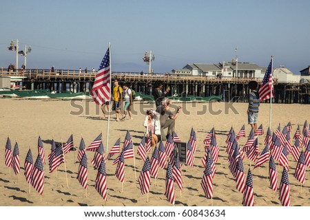 SANTA BARBARA, CA - SEP. 11: Visitors photograph 2977 U.S. Flags placed by UCSB College Republicans and Young America\'s Fdn. to remember those killed on 9/11/2001 -Sep. 11, 2010 in Santa Barbara, CA