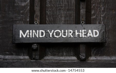 A wooden sign reads Mind Your Head.