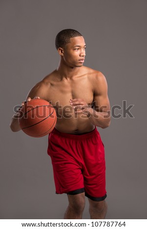 Young Black College Student Holding Basket Ball on Grey Background